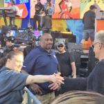 woman shaking mans hand at live event