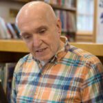 elderly man in plaid shirt