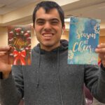 man holding holiday cards